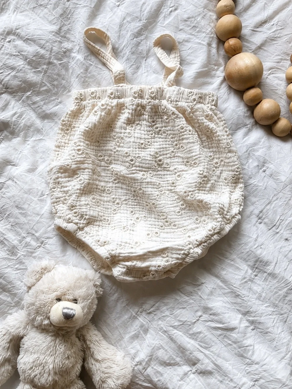 neutral cream baby bubble romper with adjustable straps